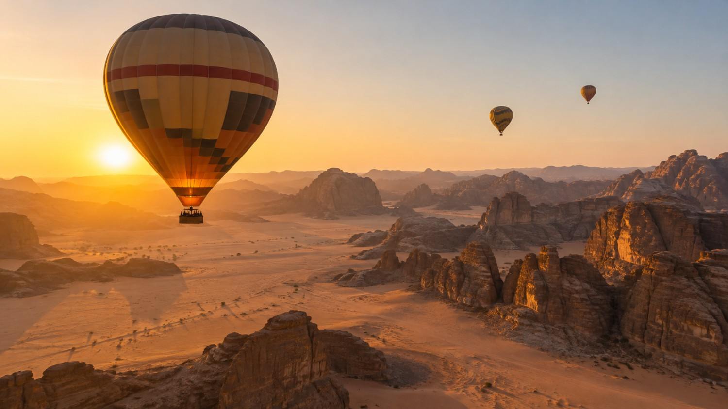 Sunrise balloon flights pass over Hegra and the AlUla landscape.